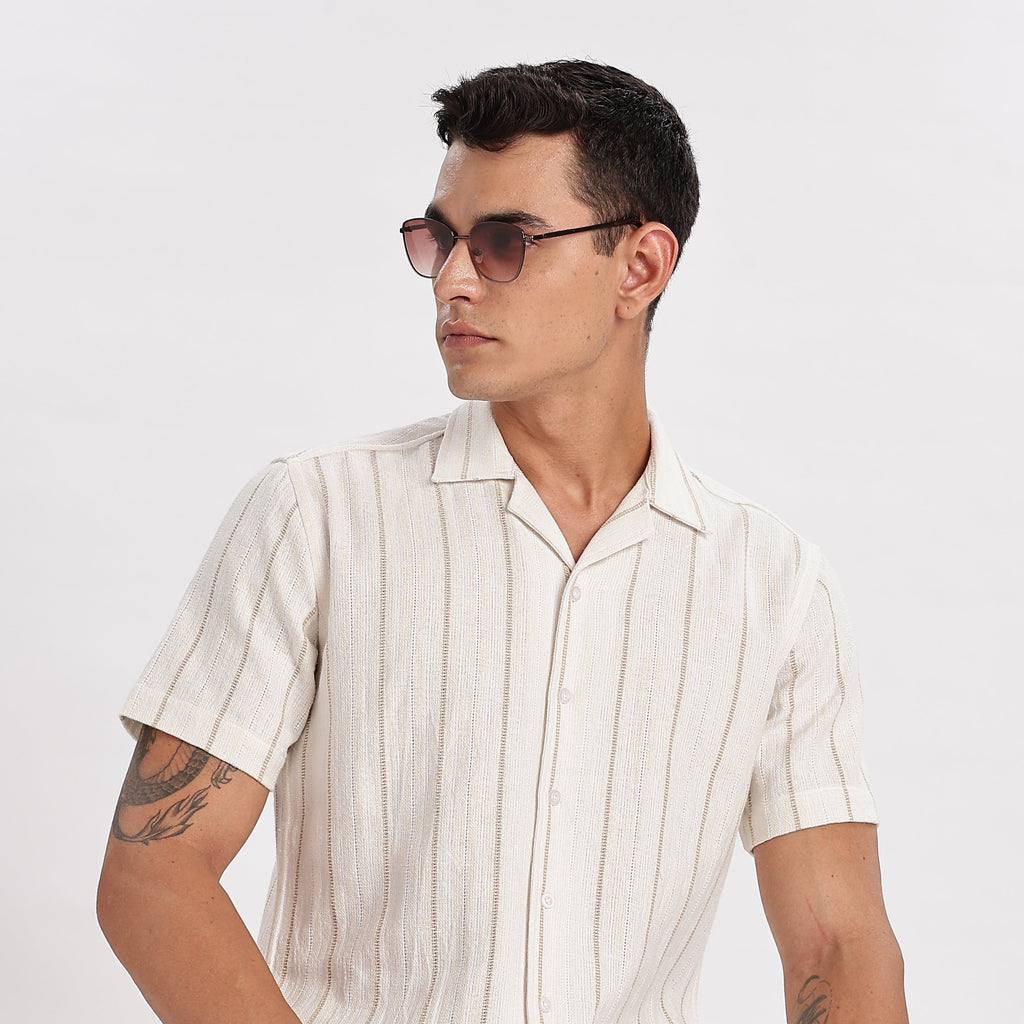 Man wearing a white striped shirt and sunglasses on a white background