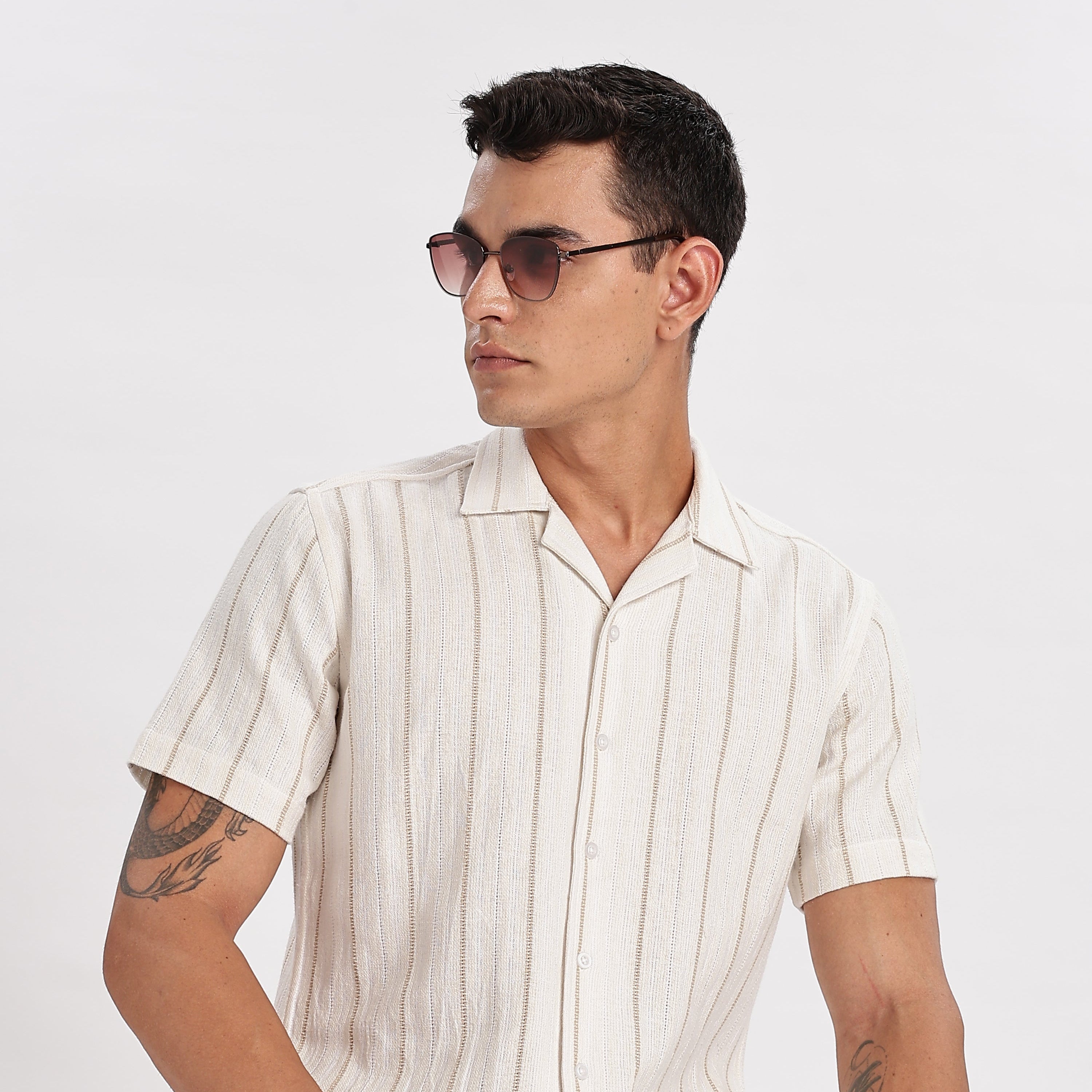 Man wearing a white striped shirt and sunglasses on a white background
